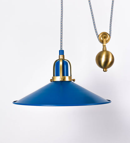 Suspensão de teto dupla composta por uma base circular azul vintage de onde descem dois cabos revestidos têxtil com linhas azuis e beges. Cada cabo passa por uma roldana em latão escovado fixa ao teto e desce até aos chapéus. Entre a base e as roldanas cada cabo sustenta uma esfera em latão escovado que atua como contrapeso para ajustar a altura. Os dois chapéus são azuis de formato cónico invertido e interior branco. No topo de cada chapéu há um suporte em latão escovado que conecta os chapéus aos cabos.